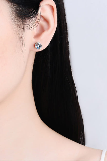 "Minimalist Moissanite stud earrings made with 925 sterling silver, rhodium-plated, featuring 1 carat Moissanite stones in each earring for a total of 2 carats. Includes a certificate of stone properties and comes with a matching box."