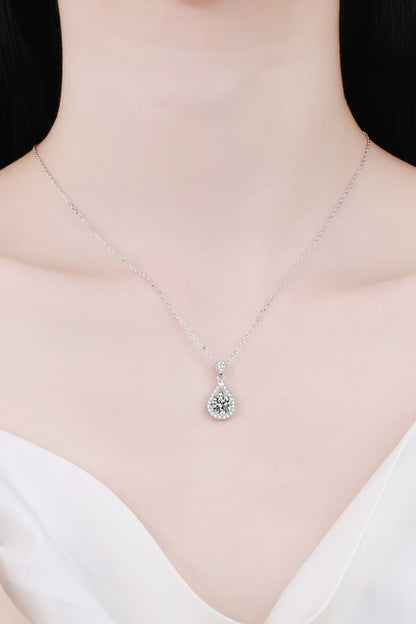 "Minimalist Moissanite pendant made with 925 sterling silver and rhodium-plated, featuring a 2-carat Moissanite stone. Includes a certificate of stone properties, matching box, and has a 16-inch chain with a 2-inch extension."