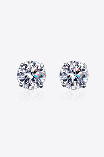 "Minimalist Moissanite stud earrings made with 925 sterling silver, rhodium-plated, featuring 1 carat Moissanite stones in each earring for a total of 2 carats. Includes a certificate of stone properties and comes with a matching box."