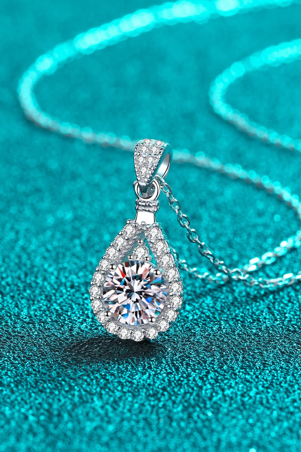 "Minimalist Moissanite pendant made with 925 sterling silver and rhodium-plated, featuring a 2-carat Moissanite stone. Includes a certificate of stone properties, matching box, and has a 16-inch chain with a 2-inch extension."