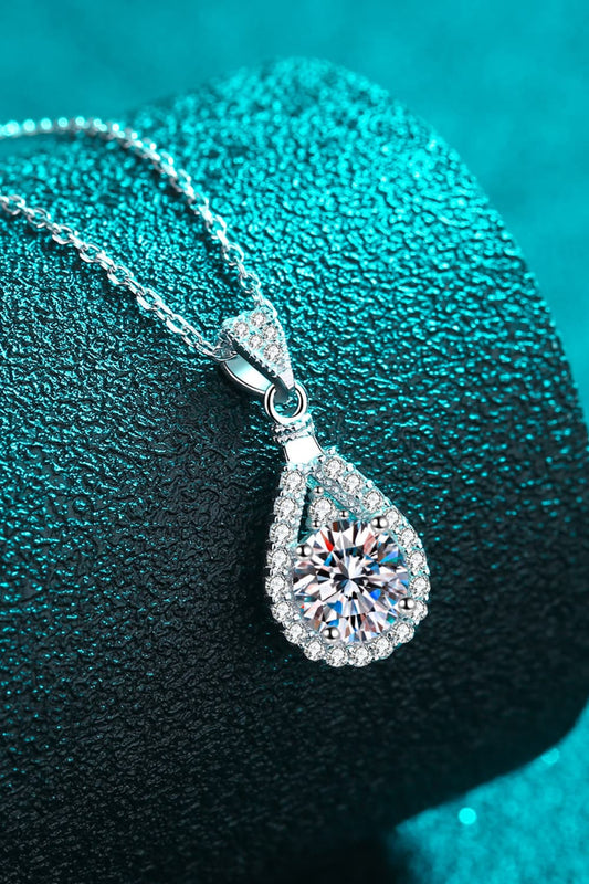 "Minimalist Moissanite pendant made with 925 sterling silver and rhodium-plated, featuring a 2-carat Moissanite stone. Includes a certificate of stone properties, matching box, and has a 16-inch chain with a 2-inch extension."